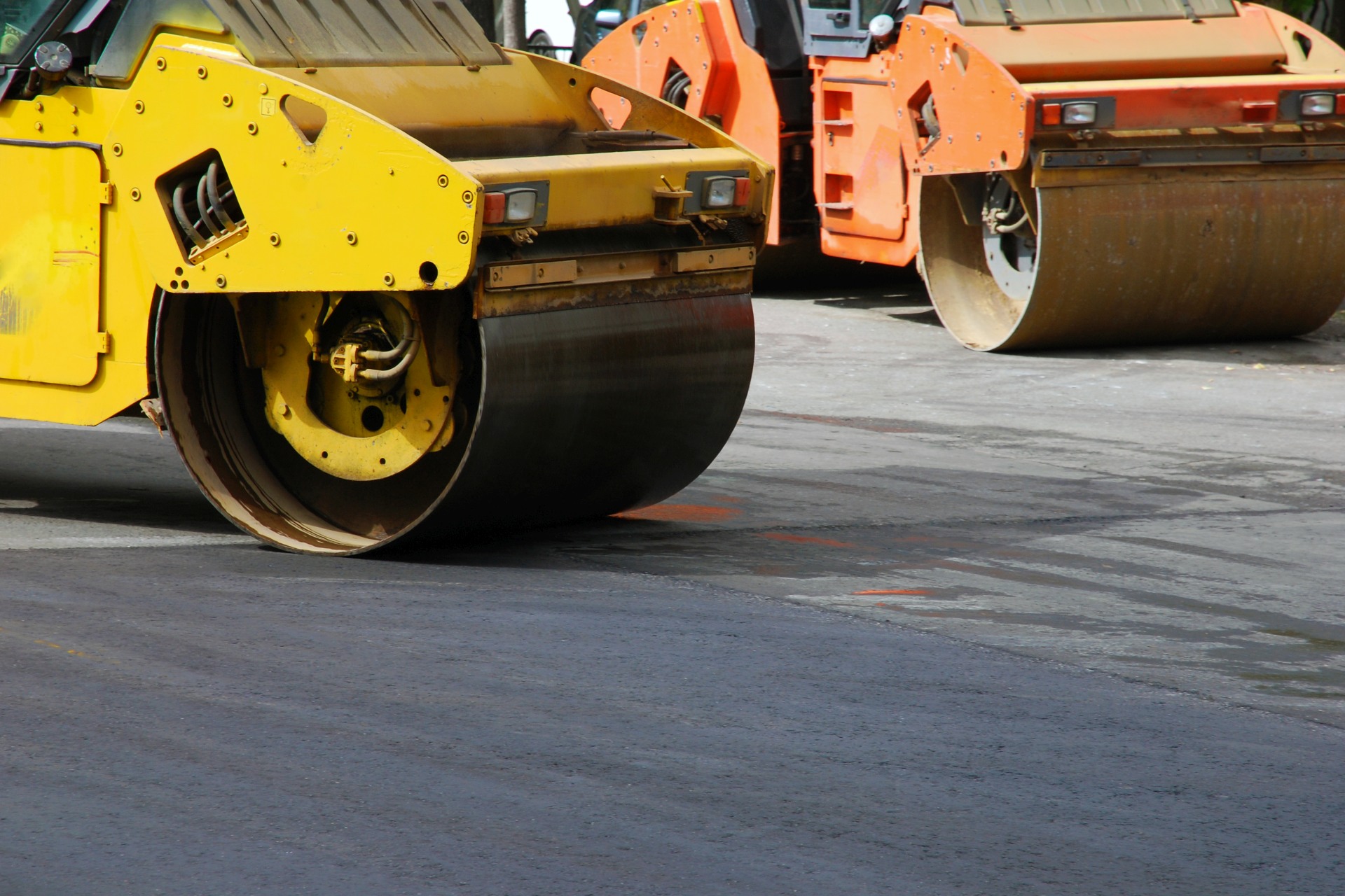 Two asphalt rollers working in the street, no people, selective focus